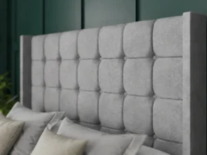 Omega Ottoman Bed with geometric buttoned floor-standing wing headboard by Dreamcraft Furniture