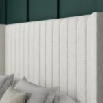 Apollo Ottoman Bed with vertical-lined floor-standing wing headboard by Dreamcraft Furniture